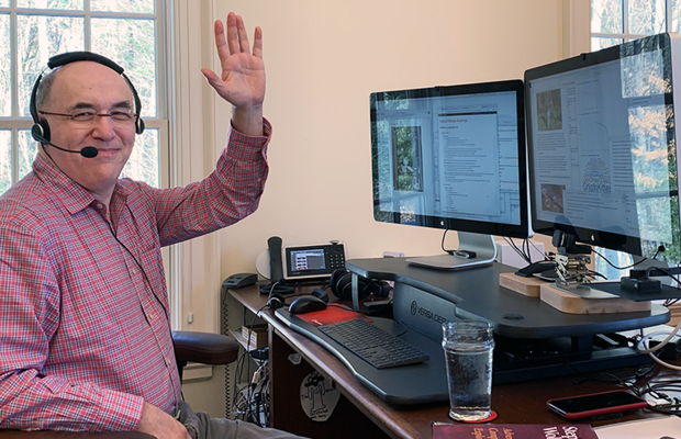 Stephen waving at desk