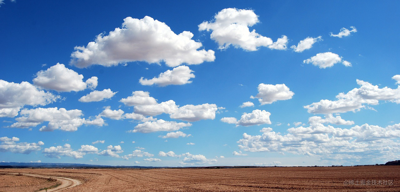 A photo of clouds against a blue sky. The clouds have shades of gray that provide depth.