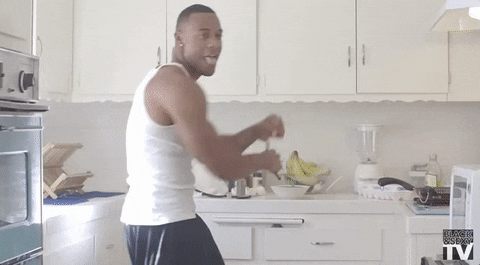 Man dancing while cooking in the kitchen